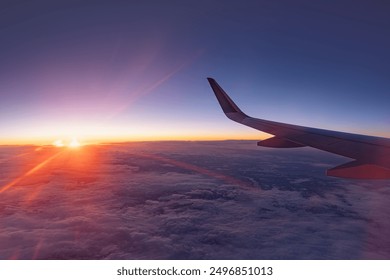 Airplane flying low over snowy mountains and preparing for landing to the airport, view from plane window of wing turbine and skyline