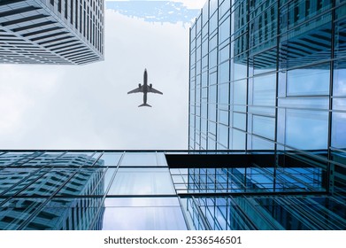 Airplane flying over buildings in city, low angle view - Powered by Shutterstock