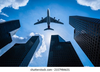Airplane flying over modern business building glass of skyscrapers in singapore city, Singapore, Business concept of architecture