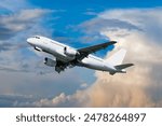 Airplane flying in the sky - travel background with flying airplane with blank livery