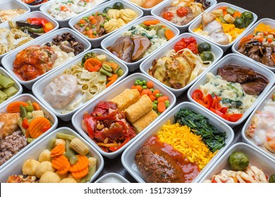 Airplane Food Presentation With Variety Of In Flight Meals.  Flight Catering.  Food On Airplanes. Salad Bar Buffet  Display In Restaurant.  Meat Cuts. Hot Appetizers. Close-up, A Lot Of Food.
