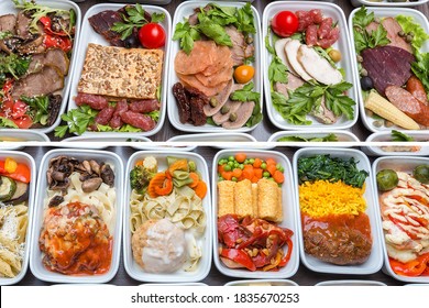 Airplane Food Presentation With Variety Of In Flight Meals. Flight Catering. Food On Airplanes. Salad Bar Buffet Display In Restaurant. Meat Cuts. Hot Appetizers. Close-up, A Lot Of Food.