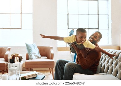 Airplane, game and father with son on a sofa, playing and bonding in their home together. Love, family and parent enjoy relationship with smiling boy, fly and fun in the living room on the weekend - Powered by Shutterstock