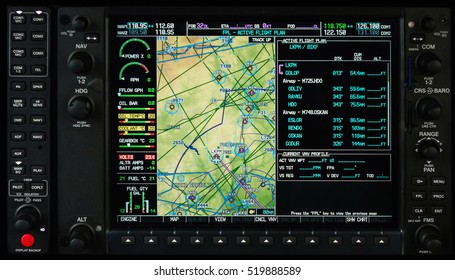 Airplane glass cockpit display with terrain and engine gauges in small private airplane