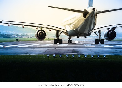 Airplane Goes To The Position For Takeoff At An Airport Runway At Mysteriously Retro Dark And Bright Twilight (copy Space)/Ready For Take Off