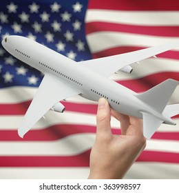Airplane in hand with national flag on background series - United States
