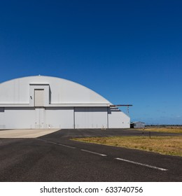 Airplane Hanger With Rounded Top And Clear Blue Sky