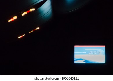 Airplane Interior At Night. Fasten Seatbelts Sign. Night Aircraft Cabin Economy Class.