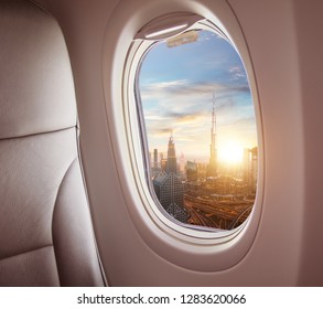 Airplane Interior With Window View Of Dubai City, UAE. Concept Of Travel And Air Transportation