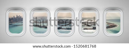 Airplane interior with window view of Dubai Pam Jumeirah Island, UAE. Concept of travel and air transportation.
