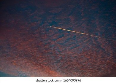 Airplane Jet Stream Track On A Sunset Colorful Sky