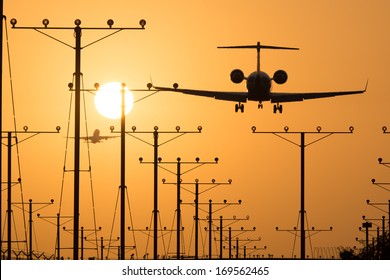 Airplane landing at Los Angeles International Airport during sunset, Los Angeles, California, USA