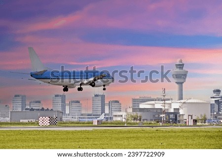 Airplane landing at Schiphol airport in the Netherlands at sunset