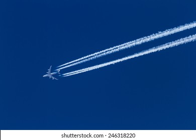 airplane leaving a long trail on a beautiful blue sky