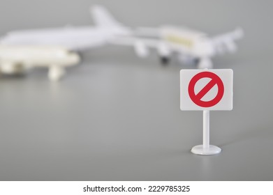 Airplane models parking at the airport area and prohibition sign
