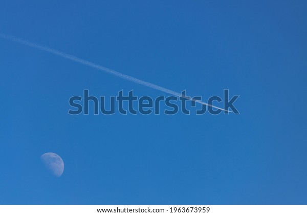 Airplane and the moon in the\
sky