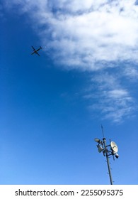 airplane, moon and telecomunication tower with blue sky and white cloud  - Shutterstock ID 2255095375