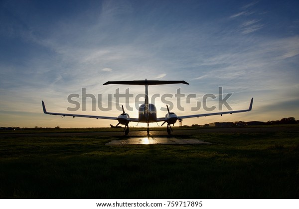 Airplane on Parking Bay\
Facing A Sunset