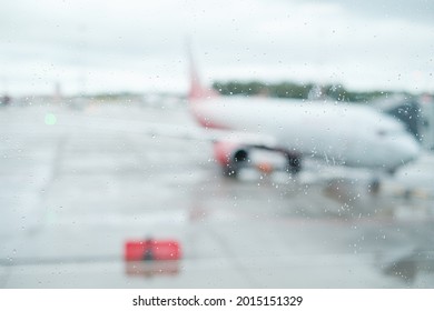 An Airplane Outside The Airport Window In Rainy Weather. No People.