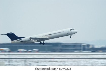 Airplane Over Snowy Runway Taking Off