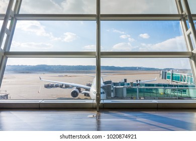 Airplane at parking position of airport waiting for next flight. The apron from passenger terminal. - Shutterstock ID 1020874921