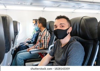 Airplane Passengers Are Wearing Medical Masks On Their Faces. Air Travel During The Coronavirus Pandemic. Airlines Requirements