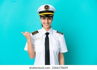 Airplane pilot caucasian woman isolated on blue background pointing to the side to present a product - Powered by Shutterstock