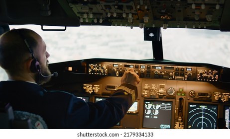 Airplane Pilot Flying Aircraft Fixing Altitude And Longitude Level, Using Plane Dashboard Command To Takeoff. Switching Power Engine And Navigation On Control Panel.