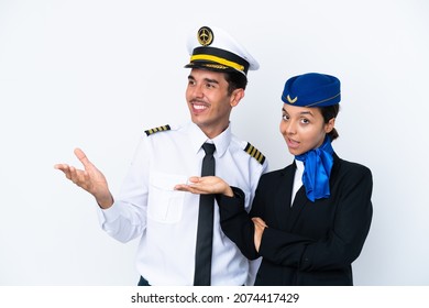 Airplane Pilot And Mixed Race Air Hostess Isolated On White Background Pointing Back And Presenting A Product