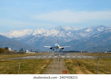Airplane plane passenger jet landing in airport with scenery mountains view. Tourism, travel, journey, wanderlust concept, air flight. Air transport flying plane, passenger transportation concept.