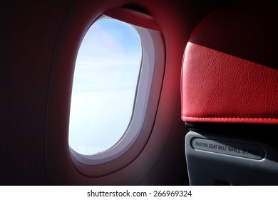 Airplane Red Seat And Window Inside An Aircraft 