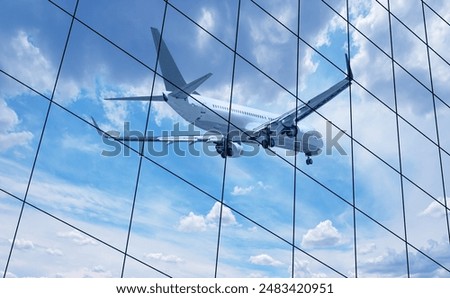 Airplane reflected in skyscraper windows