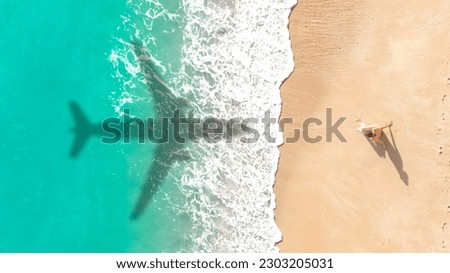 Airplane shadow flying over beautiful exotic tropical beach with woman sunbathing on a sunny day - Summer vacation travel concept