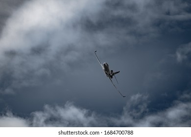 Airplane in the sky - cloudy day. Dramatic cloudy sky.