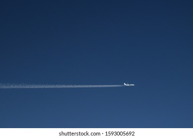 Airplane in the sky - KLM airline. Horizontal trajectory on blue sky. High altitude picture. Space for typing text.