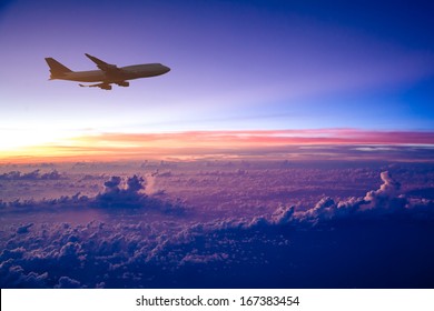 Airplane in the sky at sunrise - Powered by Shutterstock