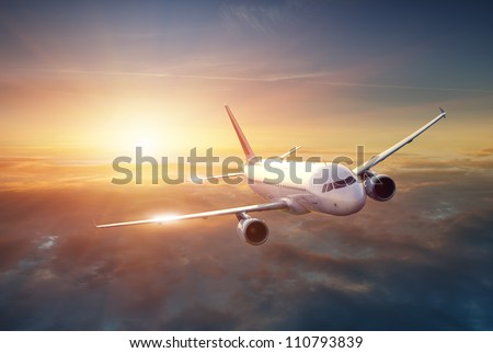 Airplane in the sky at sunset