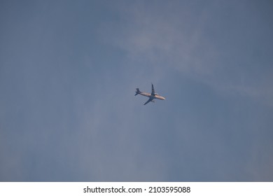 
Airplane in the sky with thin clouds