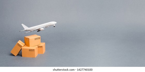 Airplane and stack of cardboard boxes. concept of air cargo and parcels, airmail. Fast delivery of goods and products. Cargo aircraft. Logistics, connection to hard-to-reach places. Banner, copy space