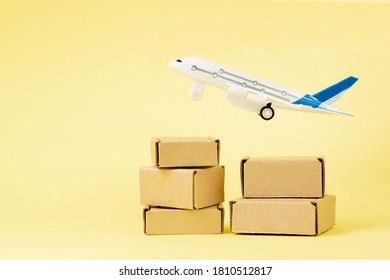 Airplane and stack of cardboard boxes. concept of air cargo and parcels, airmail. Fast delivery of goods and products. Cargo aircraft. Logistics, connection to hard-toreach places. Banner, copy space.