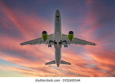 Airplane in the sunset sky flight travel transport airline background concept..