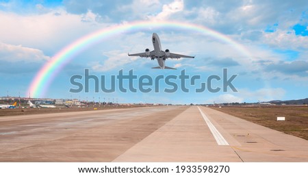 Airplane taking off from the airport with rainbow