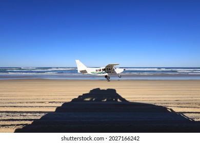 Airplane Taking Off On The Beach On Fraser Island With A 4wd Four Wheel Drive Shadow In The Foreground