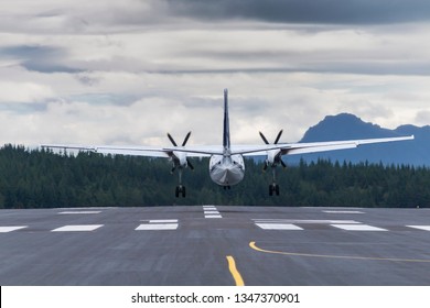 Airplane Touchdown On Landing Path Back View Tele Lens