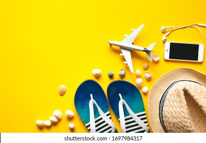 Airplane Toy And Passport, Money, Ticket, Phone, Watch, Headphones. Travel Accessories And Objects On Yellow Background With A Top View And Copy Space . Web Banner Or Poster  For Travel  Agency.