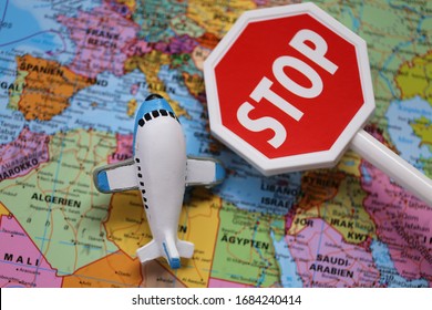 Airplane Traffic Limitations. Air Traffic Stopped.Air Travel Prohibited.Ban On Air Travel.Coronavirus Epidemic Problem. Decorative Airplane And Stop Sign On World Map Background.Flying On A Plane Ban