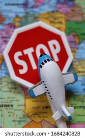 Airplane Traffic Limitations. Air Traffic Stopped.Air Travel Prohibited.Ban On Air Travel.Coronavirus Epidemic Problem. Decorative Airplane And Stop Sign On World Map Background.