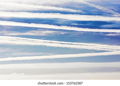 airplane trails and lines in blue sky