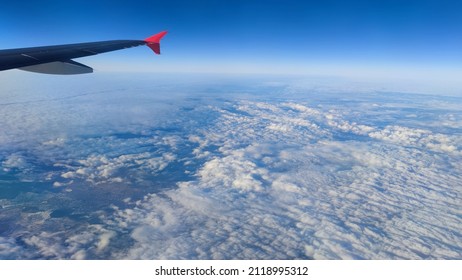 airplane traveling window view to sky, clouds. Photo for advertising travel agency, landscape view over clouds air travel. Clear blue sky with clouds below, paradise concept. Vienna city aerial view - Powered by Shutterstock
