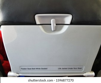 Airplane Tray Table on seat back for mockup banner or design advertising on blank area, already closed, copy space.